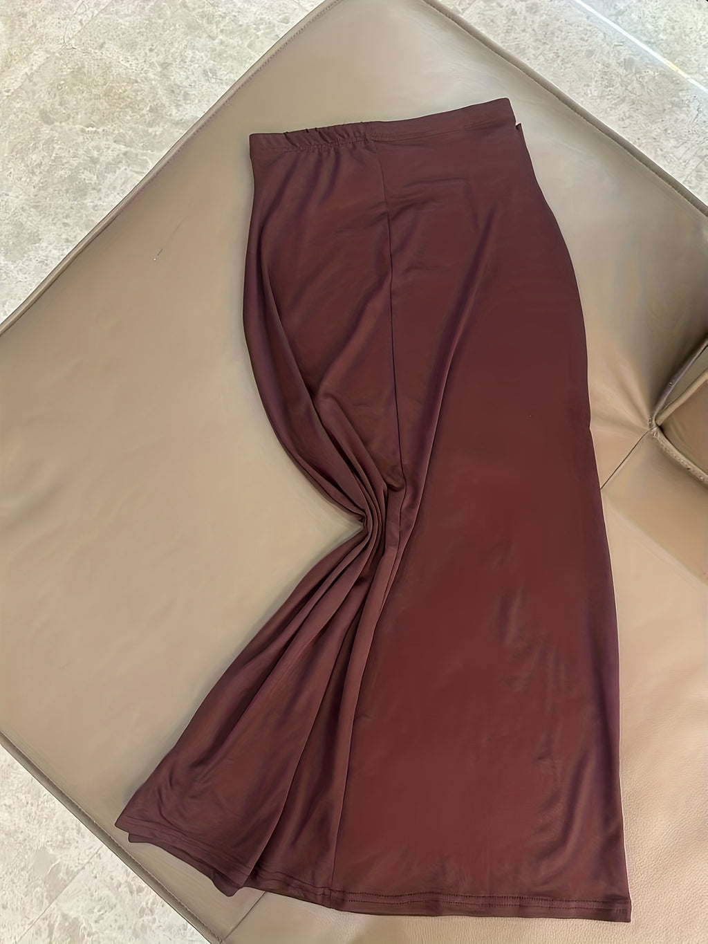 A Stylish And Sophisticated Set Featuring a Backless Halter Neck Top with a Unique Metallic Buckle, Paired with a Long Bodycon Skirt That Has an Elastic Waist