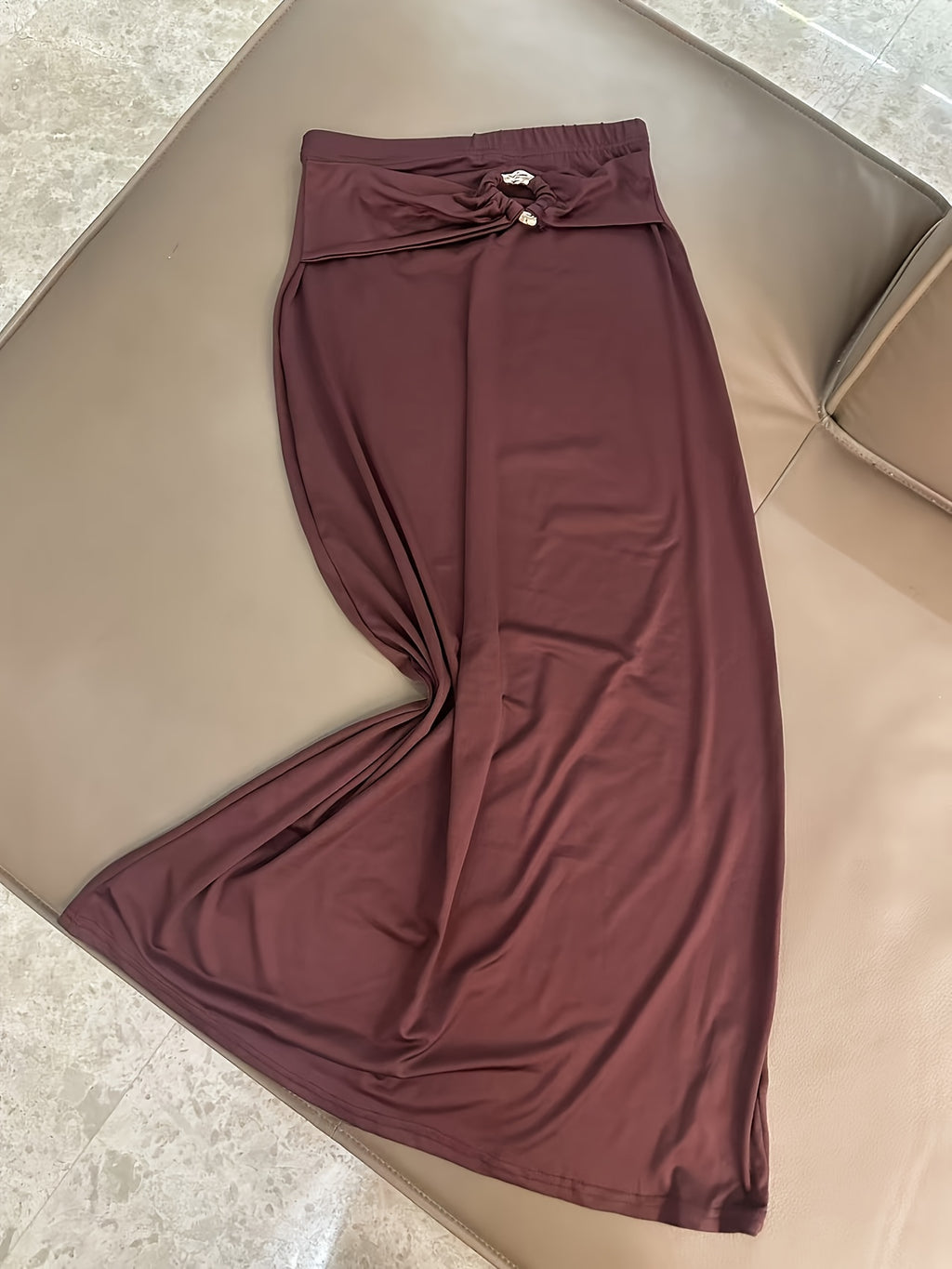A Stylish And Sophisticated Set Featuring a Backless Halter Neck Top with a Unique Metallic Buckle, Paired with a Long Bodycon Skirt That Has an Elastic Waist